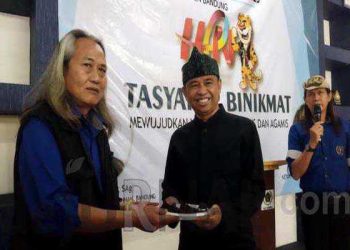 Ketua PWI Kabupaten Bandung H. Rahmat Sudarmaji menyerahkan kue kepada Kadiskominfo Yudi Abdurohman. (Sopandi/ dejurnal.com).